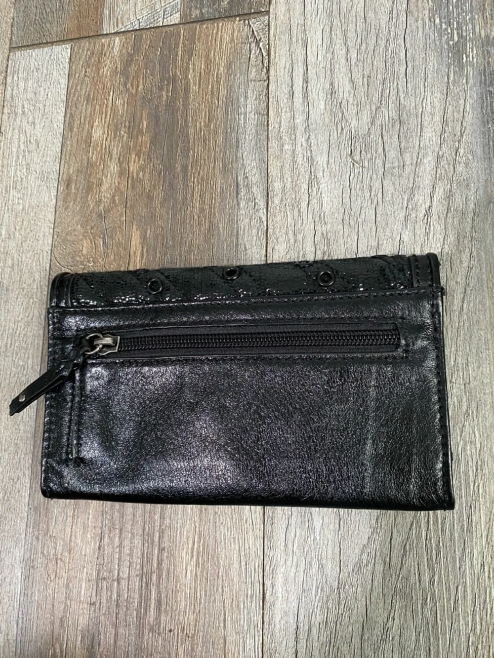 The Sak Black Quilted Eyelet Trifold Leather Wallet with Logo Plaque